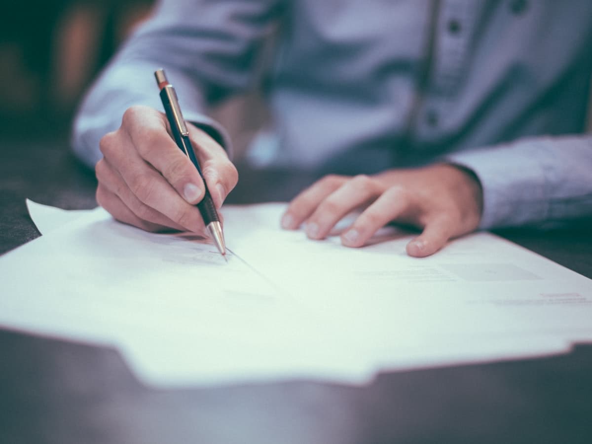 A person reviewing and signing claim paperwork
